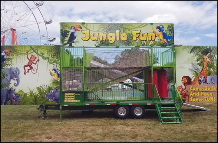 A colorful outdoor jungle-themed play structure with animal illustrations and a sign that says Jungle Fun and invites people to come in and have fun. Description generated by AI