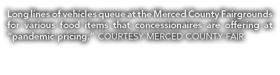 Long lines of vehicles queue at the Merced County Fairgrounds for various food items that concessionaires are offerin   