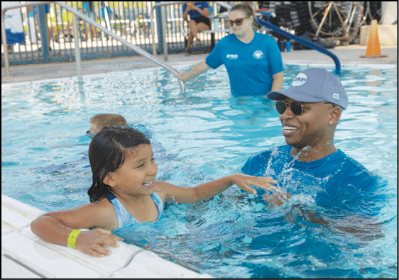 U.S. Olympic Gold Medalist, Cullen Jones, helps students learn water safety skills at the Valley of The Sun YMCA/Leslie's World's Largest Swimming Lesson event in Phoenix, AZ. Jones shared his personal water safety/learn to swim story to help raise awareness about the importance of learning to swim and using layers of protection including adult supervision and preventing access to water with fencing and pool covers.