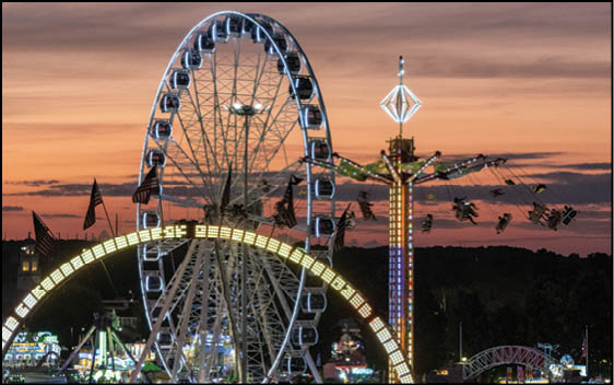 The rides of the Midway light up the night during the Big E at the Eastern States Exposition grounds in West Springfield, Massachusetts on Thursday, September 19, 2024. Photo by Christopher Evans