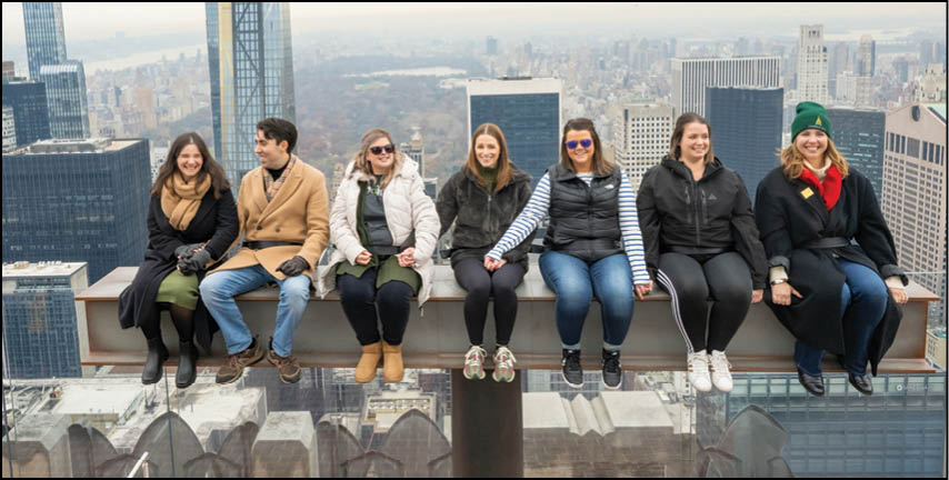 Visitors experience the opportunity to recreate the famous 1932 photograph “Lunch Atop a Skyscraper,” depicting 11 ironworkers precariously perched on a steel beam while 30 Rockefeller Plaza was under construction. Now, 91 years later, The Beam has returned to Top of the Rock for an interactive photo experience on the 69th floor, Friday, Dec. 1, 2023 in New York. (Diane Bondareff/AP Images for Tishman Speyer)