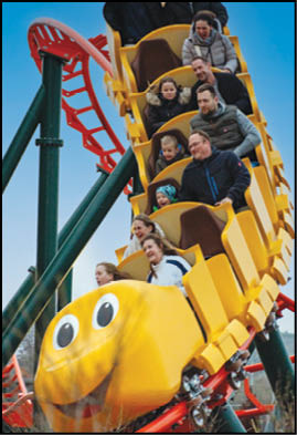 A yellow train with a face on the front of it. Description generated by AI