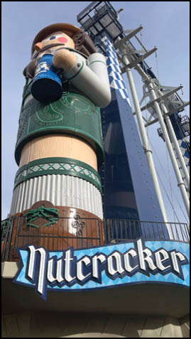 A large statue of a man holding a beer. Description generated by AI