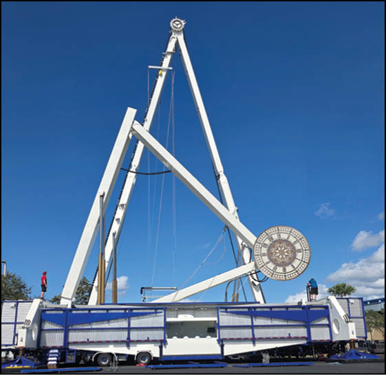 A large blue and white structure with a wheel on top. Description generated by AI