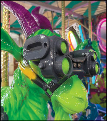 A green and yellow merry go round with a gun on it. Description generated by AI