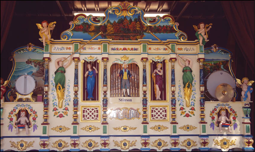 A large, colorful carousel with a variety of figures and decorations. Description generated by AI