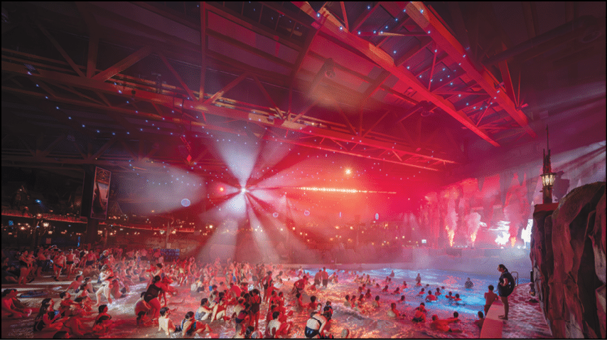 A large group of people are in a pool with red lights. Description generated by AI
