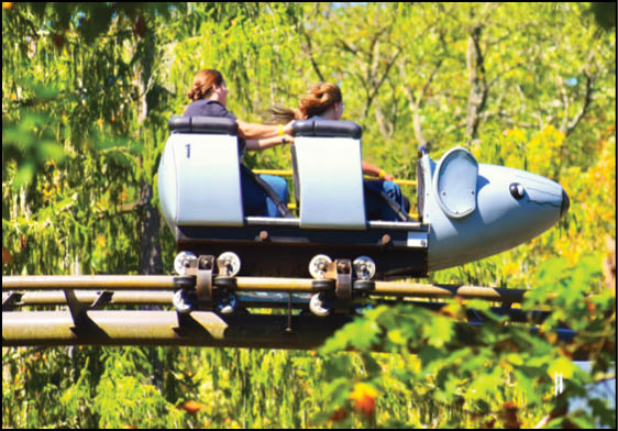 A roller coaster with two people riding it. Description generated by AI