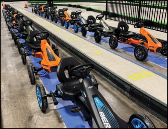 A row of scooters are parked in a garage. Description generated by AI