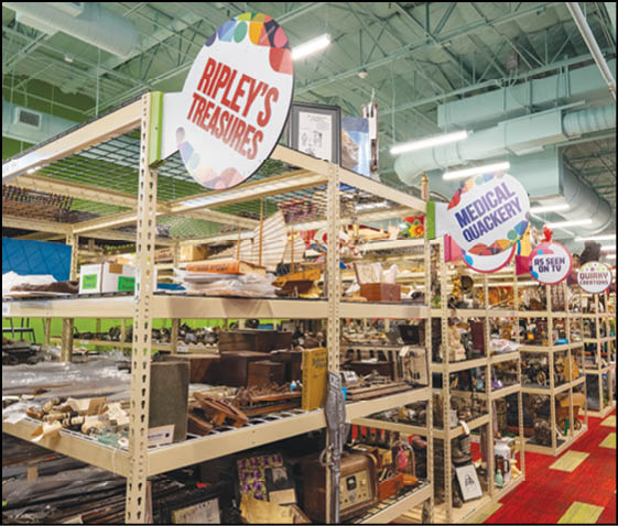 A store with a red floor and shelves full of items. Description generated by AI