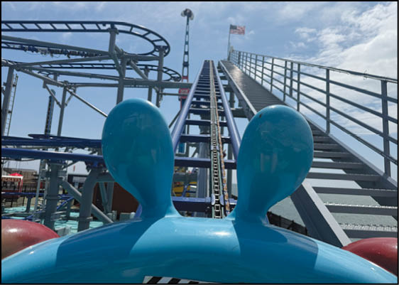 A blue and white roller coaster with a blue and white car. Description generated by AI
