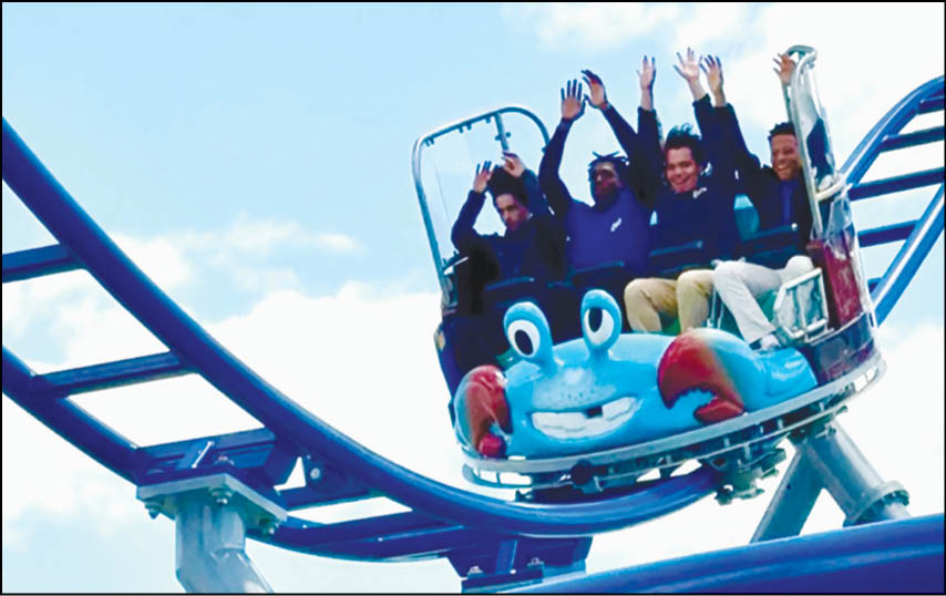 A group of people are riding a roller coaster. Description generated by AI