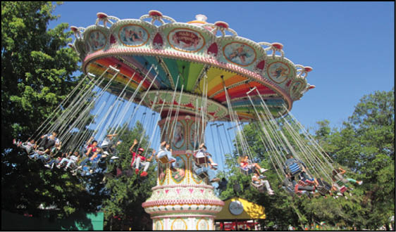 A large carousel with many riders on it. Description generated by AI