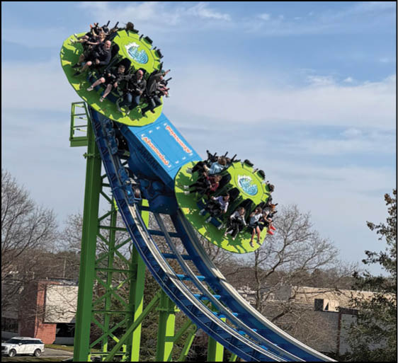 A roller coaster with green and yellow wheels. Description generated by AI