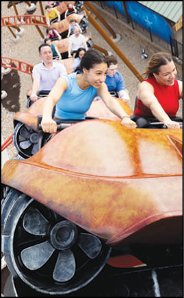 A group of people riding a roller coaster. Description generated by AI