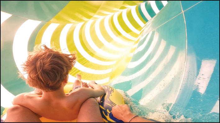 A person is riding a water slide. Description generated by AI