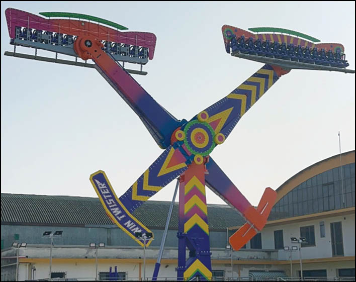 A large, colorful carnival ride with a purple and yellow design. Description generated by AI