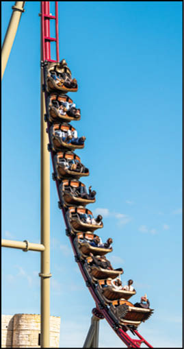 A roller coaster with people riding it. Description generated by AI