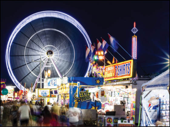 A carnival with a large wheel and a Ferris wheel. Description generated by AI