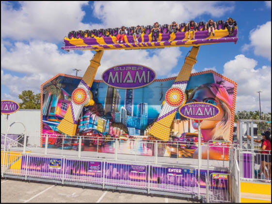 A purple and yellow Miami ride with people on it. Description generated by AI