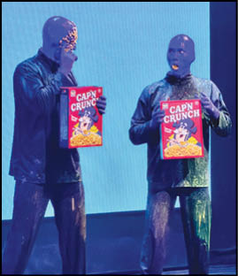 Three men holding boxes of cereal. Description generated by AI