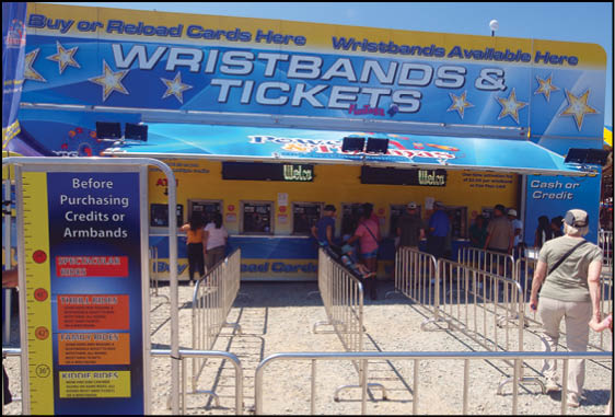 A blue and yellow tent with a sign that says “Buy or Reload Cards Here". Description generated by AI