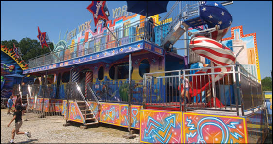 A colorful carnival ride with a red, white, and blue theme. Description generated by AI