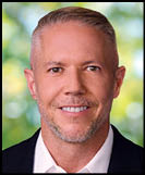 A man wearing a white shirt and black jacket. Description generated by AI