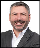 A man wearing a suit and tie. Description generated by AI