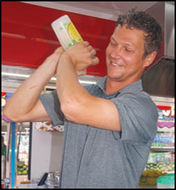 A man holding a bottle of lemon juice. Description generated by AI