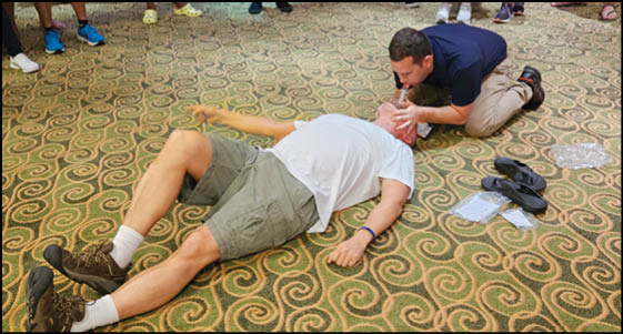 A man is lying on the floor with his shirt off. Description generated by AI