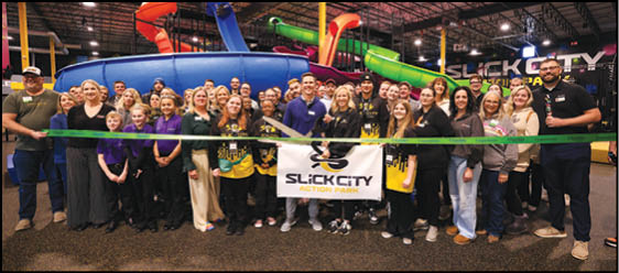 A group of people are standing in front of a banner. Description generated by AI