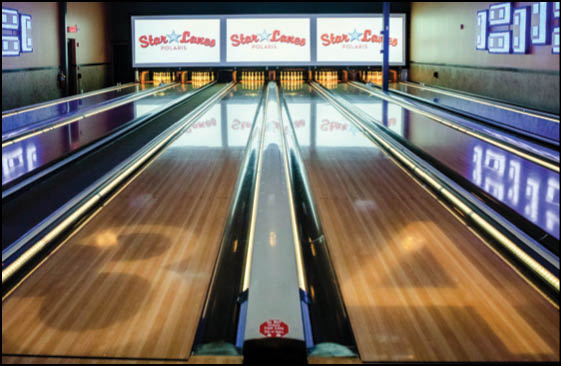 A bowling alley with a purple and white floor. Description generated by AI