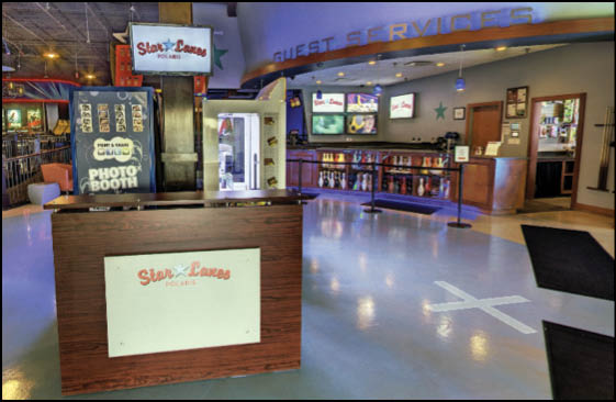 A large room with a wooden counter and a sign that says “welcome to the jungle". Description generated by AI
