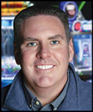 A man wearing a blue jacket and a blue shirt. Description generated by AI