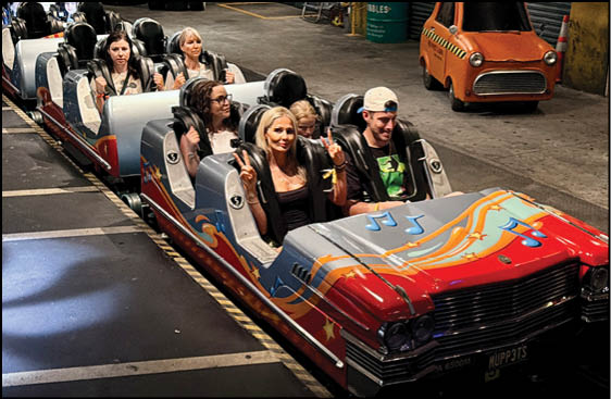 A group of people are riding a roller coaster. Description generated by AI