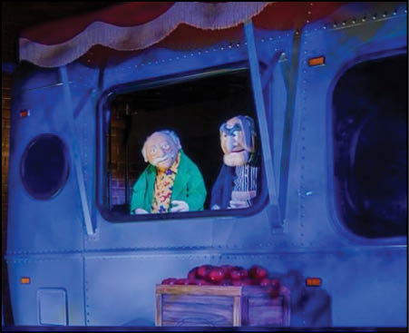 A group of people riding a train with blue lights. Description generated by AI