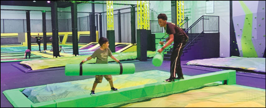 A man and a child are playing in a green and yellow room. Description generated by AI