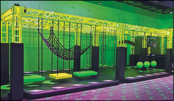 A glowing green room with a swing set and a ball pit. Description generated by AI