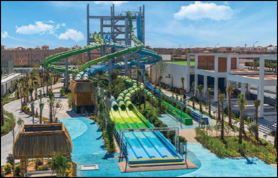 A large water slide with a yellow and blue tube. Description generated by AI