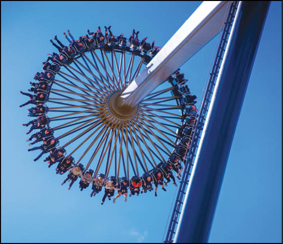 A large group of people are riding a roller coaster. Description generated by AI