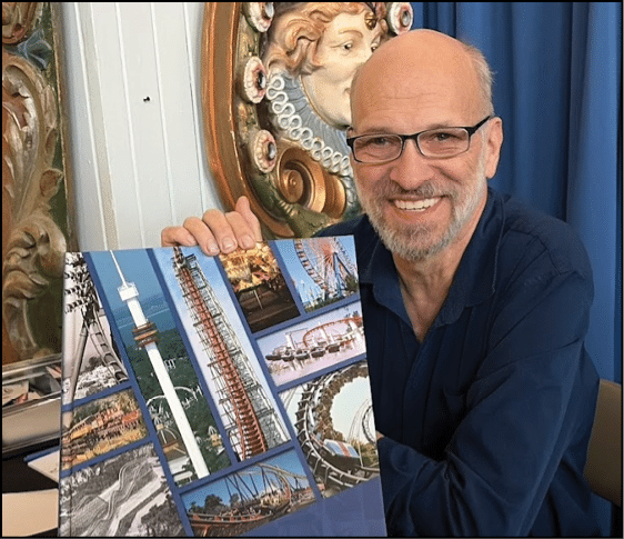 A man is holding a book about Cedar Point. Description generated by AI