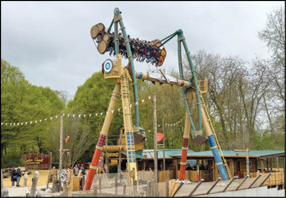 A large wooden roller coaster with a yellow and red design. Description generated by AI