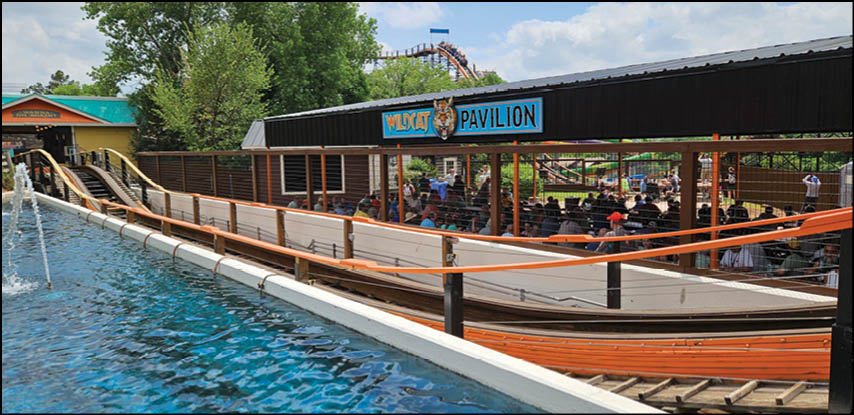 A wooden fence in front of a water slide. Description generated by AI