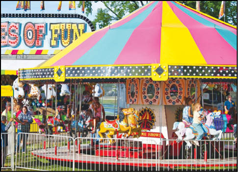 A blue and yellow tent with a sign that says “Buy or Reload Cards Here". Description generated by AI