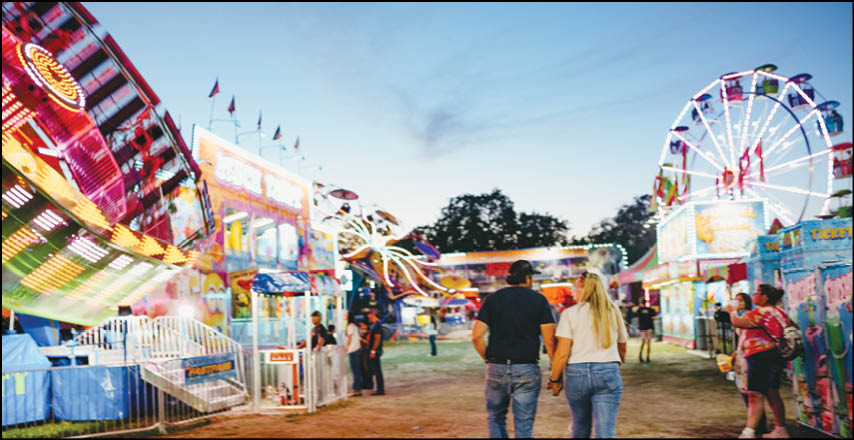 A blue and yellow tent with a sign that says “Buy or Reload Cards Here". Description generated by AI
