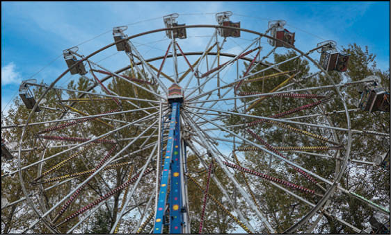 A blue and yellow tent with a sign that says “Buy or Reload Cards Here". Description generated by AI