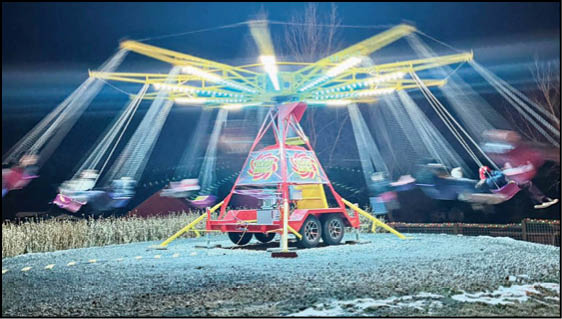 A blue and yellow tent with a sign that says “Buy or Reload Cards Here". Description generated by AI
