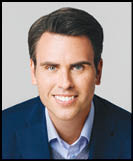 A man wearing a white shirt and black jacket. Description generated by AI