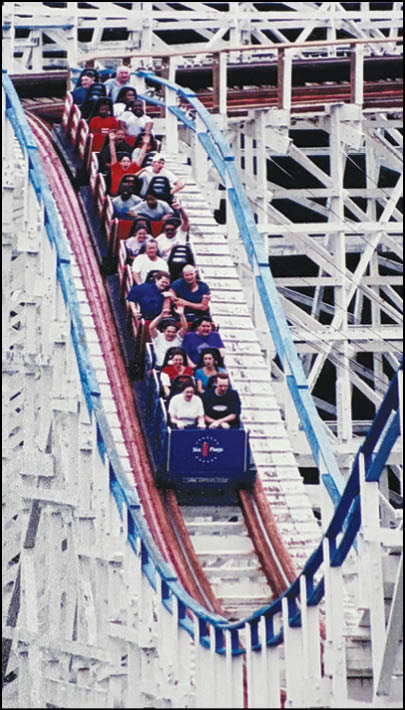 A group of people riding a train with blue lights. Description generated by AI